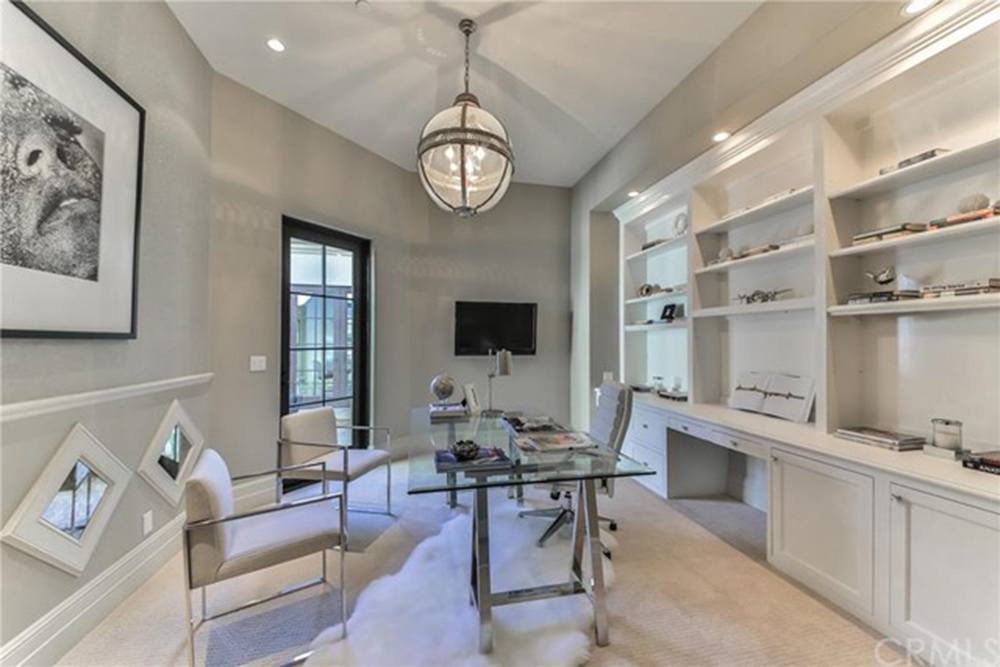 A study or office with white shelving