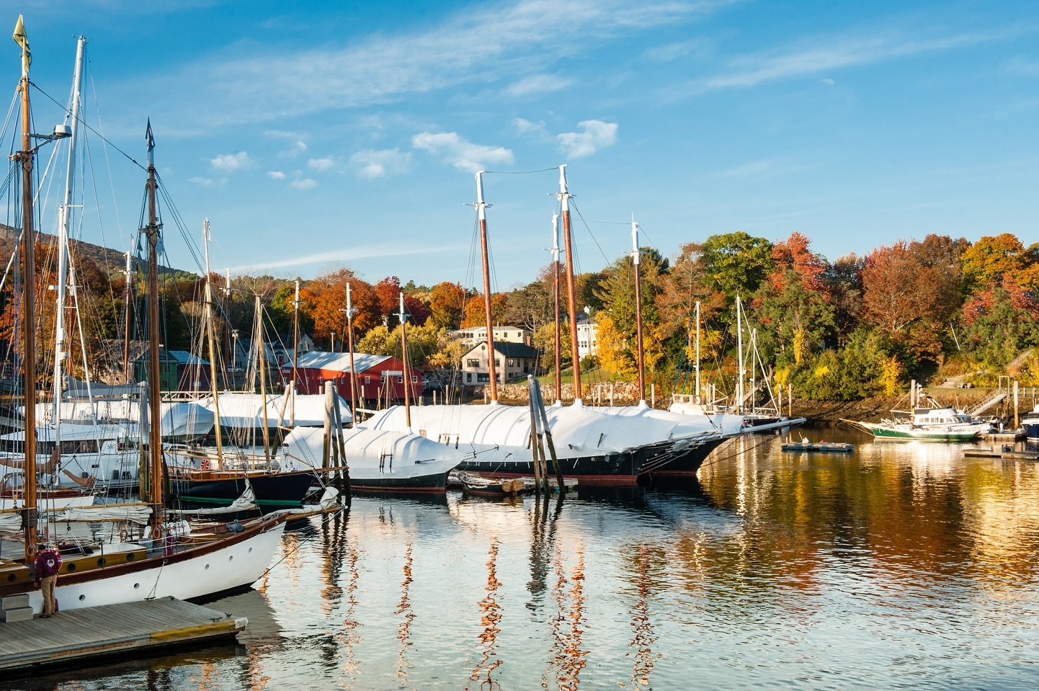 Camden, Maine harbor with bright fall foliage in autumn