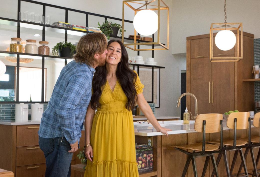 Chip and Joanna Gaines stand in a fully renovated kitchen.