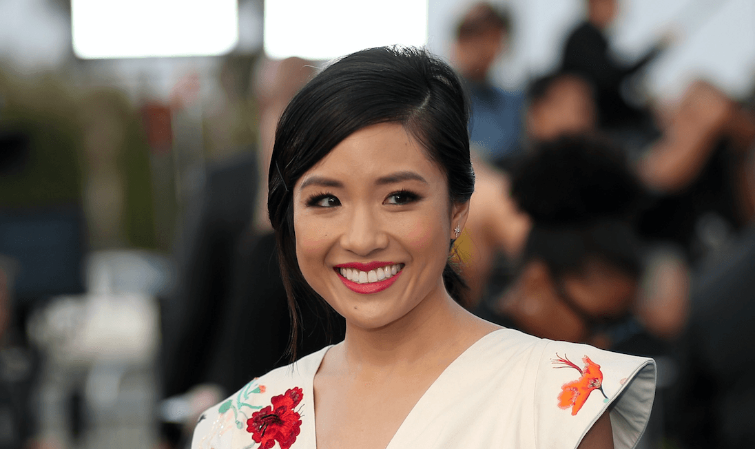 Constance Wu smiling on a red carpet.