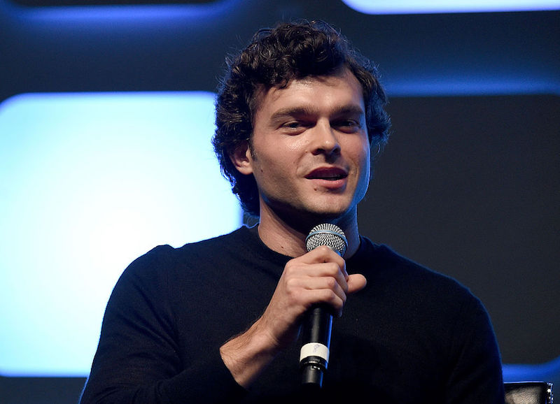 Alden Ehrenreich sits and speaks into a microphone. Alden Ehrenreich sits and speaks into a microphone.