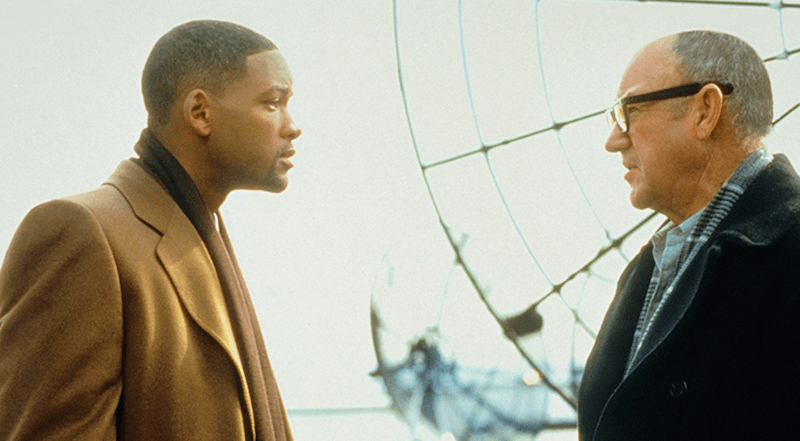 Will Smith and Gene Hackman talking in front of a large wheel in 'Enemy State of Mind'.