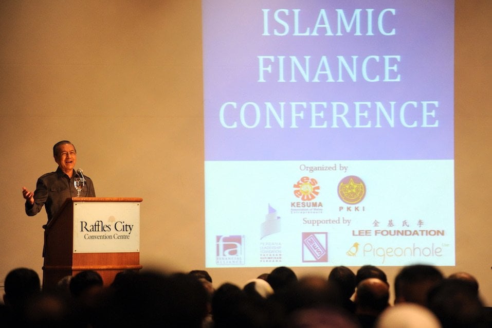 Former Malaysian prime minister Mahathir Mohamad gestures as he speaks at an Islamic finance conference in Singapore