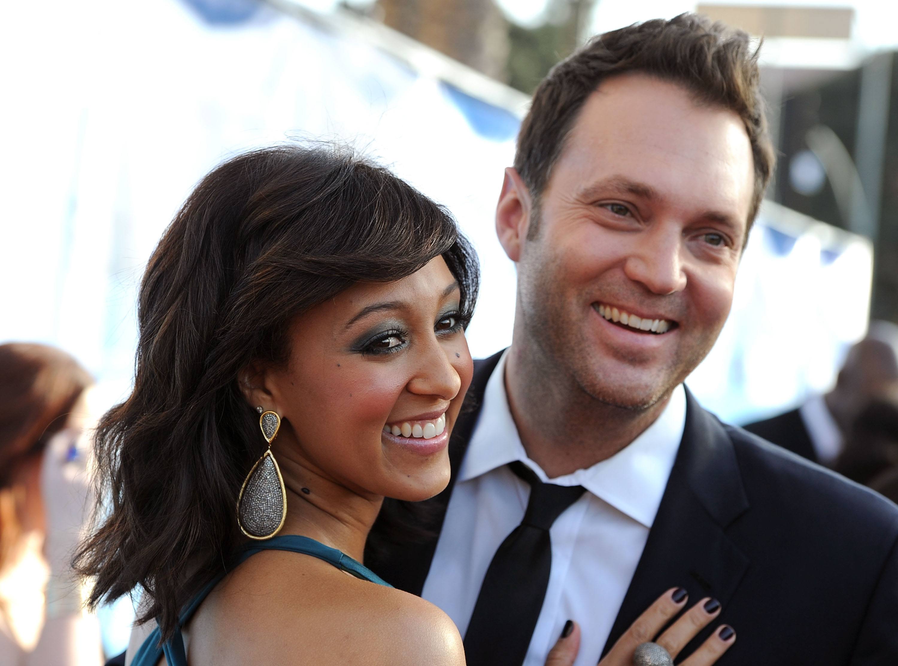 Actress Tamera Mowry and reporter Adam Housley arrive at the 42nd NAACP Image Awards held at The Shrine Auditorium on March 4, 2011 in Los Angeles, California. 