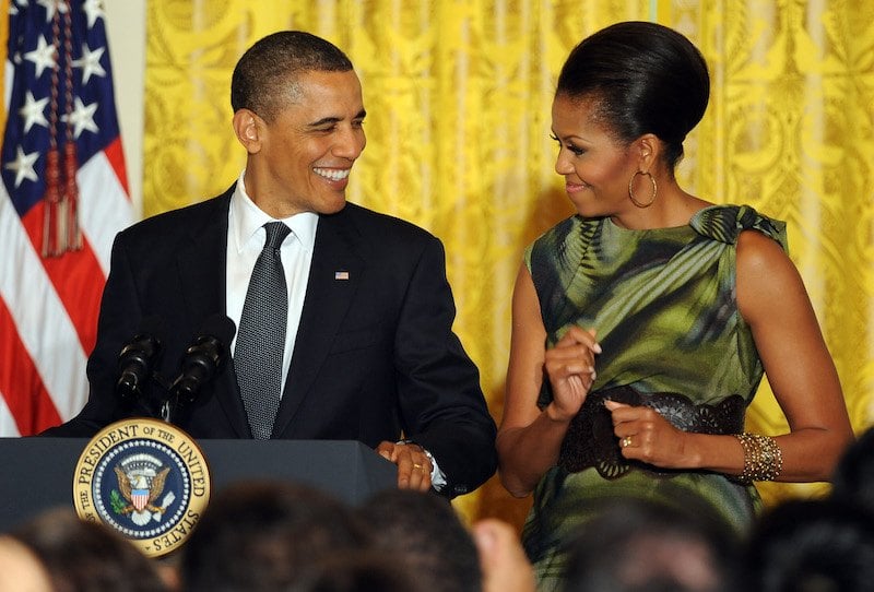 U.S. President Barack Obama speaks as First Lady Michelle Obama looks on du