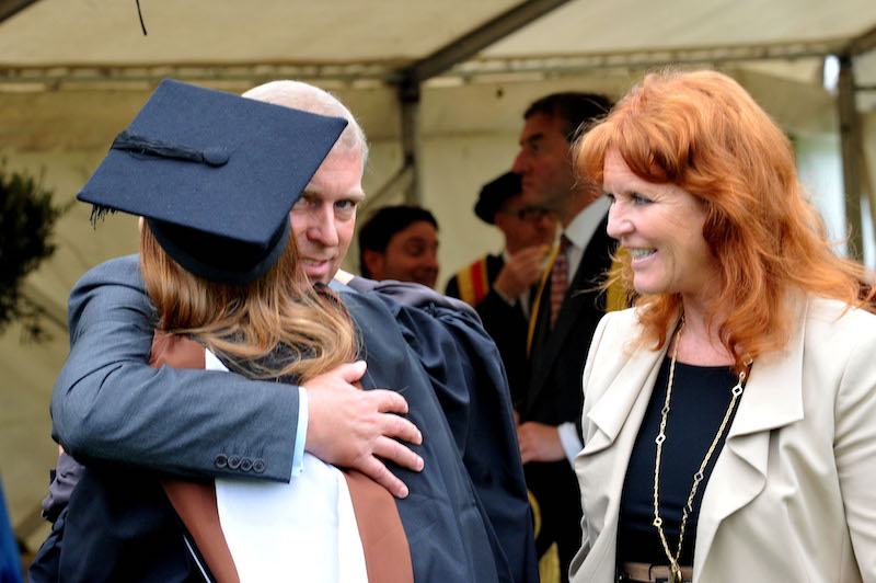 Prince Andrew, the Duke York (L), watched by Sarah, Duchess of York, hugs his daughter, Princess Beatrice