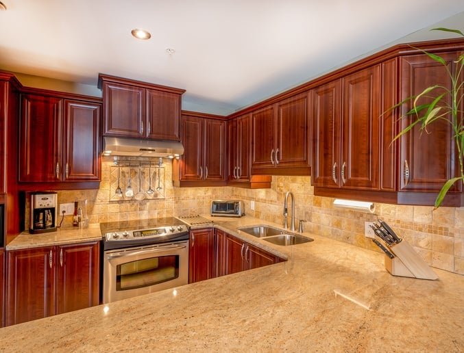 kitchen with granite and brown cabinets