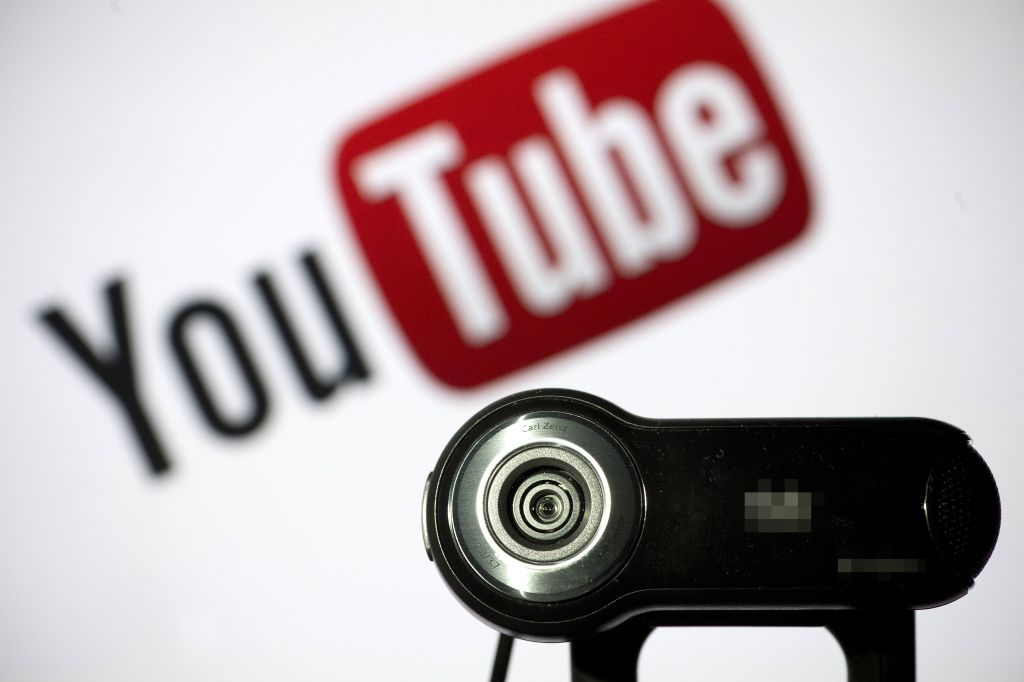 a webcam in front of the youtube logo a webcam in front of the youtube logo