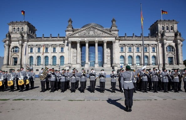 A military marching band performs prior to a swearing-in ceremony for new recruits of the Bundeswehr, the armed forces of the Federal Republic of Germany, in front of the Reichstag building.