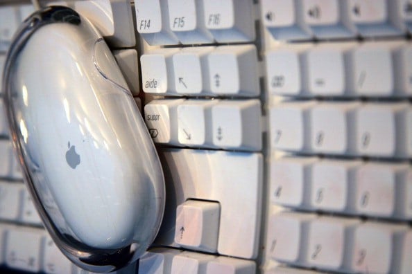 Apple computer mouse on a keyboard Apple computer mouse on a keyboard