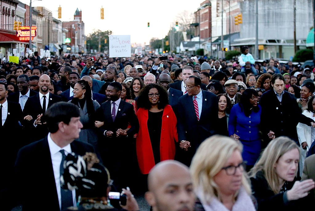 Oprah, along with members of the cast of "Selma" walk down Broad St. towards the Edmund Pettus Bridge accompanied by thousands of participants in honor of Rev. Martin Luther King Jr. Day oprah marches for equality in selma