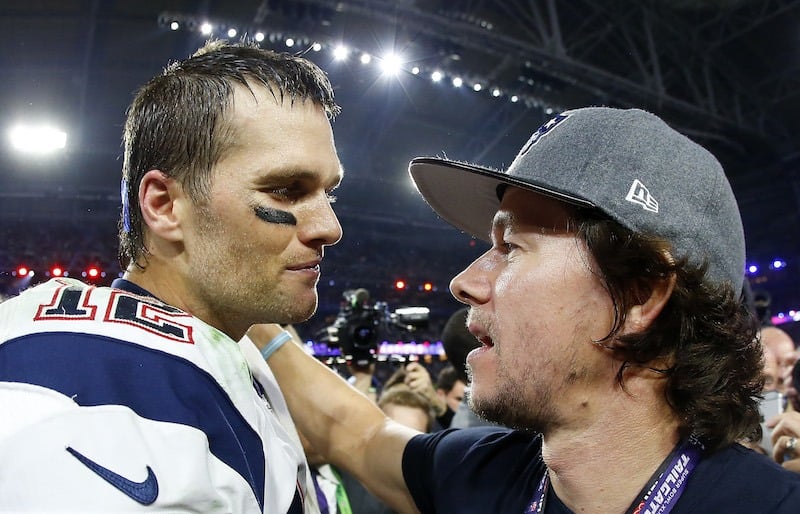 Tom Brady #12 of the New England Patriots celebrates with Mark Wahlberg after defeating the Seattle Seahawks 28-24 to win Super Bowl XLIX at University of Phoenix Stadium on February 1, 2015 in Glendale, Arizona.