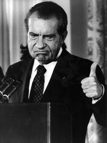 Nixon gives a thumbs-up after announcing his resignation