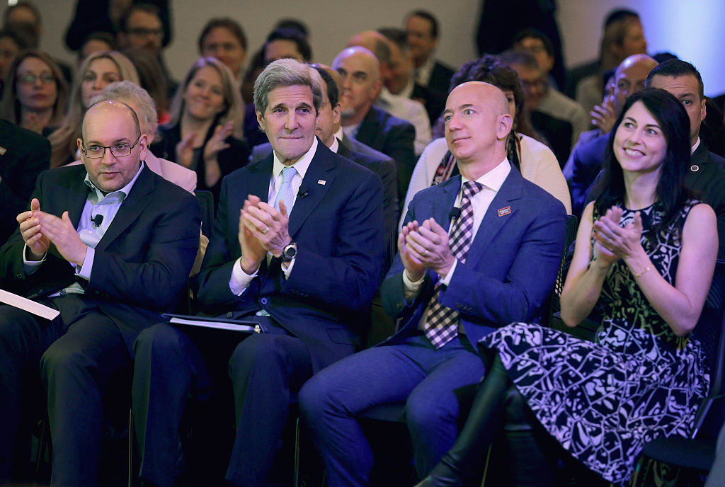 Washington Post reporter and former Tehran bureau chief Jason Rezaian, former U.S. Secretary of State John Kerry, Jeff Bezos and his wife MacKenzie Bezos participate in the opening ceremony of the newspaper's new location