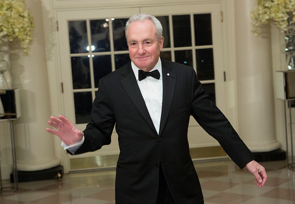 Lorne Michaels waving in a tuxedo.