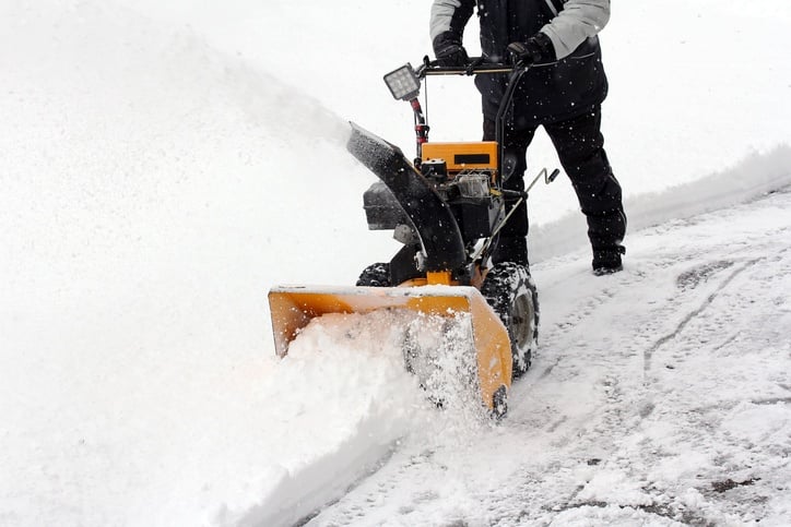 person using a snow blower