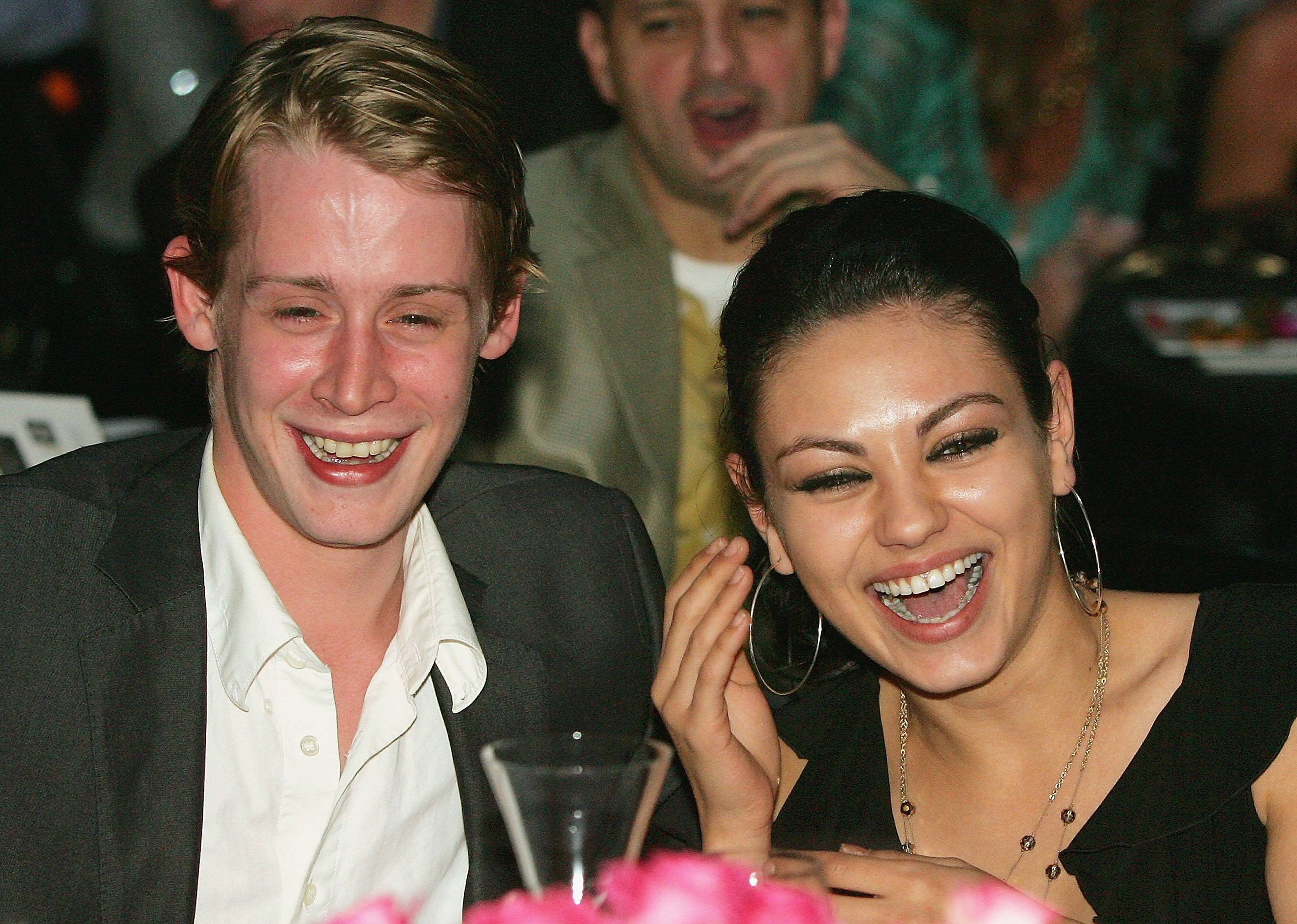 Macaulay Culkin and Mila Kunis laughing together