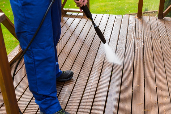 cleaning a deck with a pressure washer