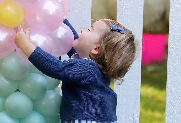 Princess Charlotte hugging balloons