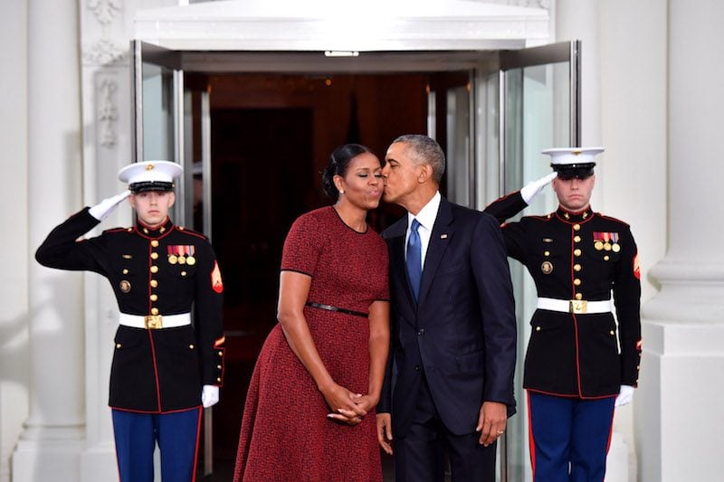  President Barack Obama (R) gives Michelle Obama a kiss