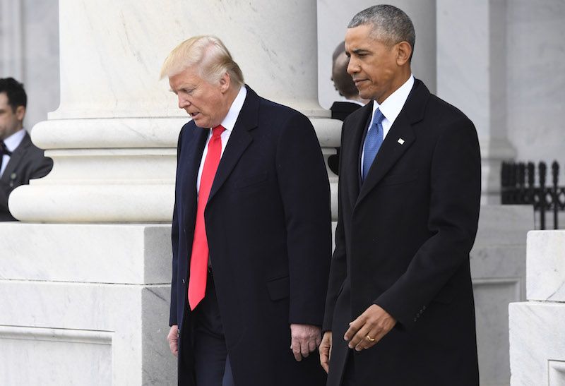 President Donald Trump and former President Barack Obama walking side by side. 