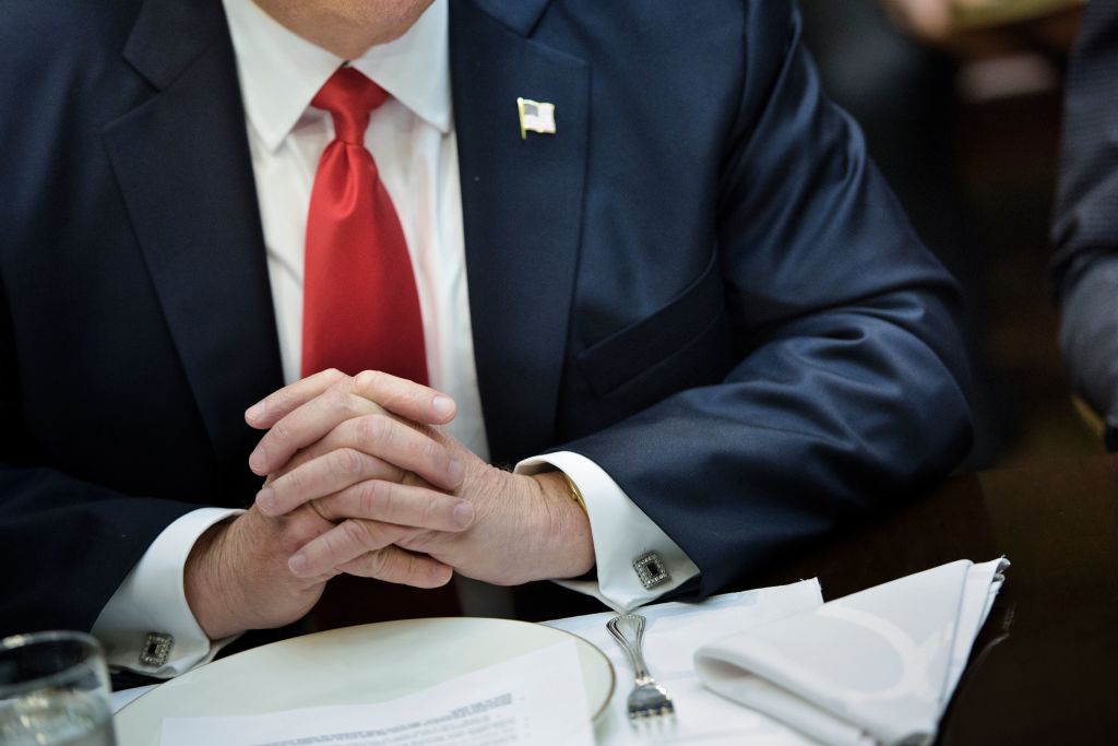 trump's hands folded in front of a dinner plate trump's hands folded in front of a dinner plate