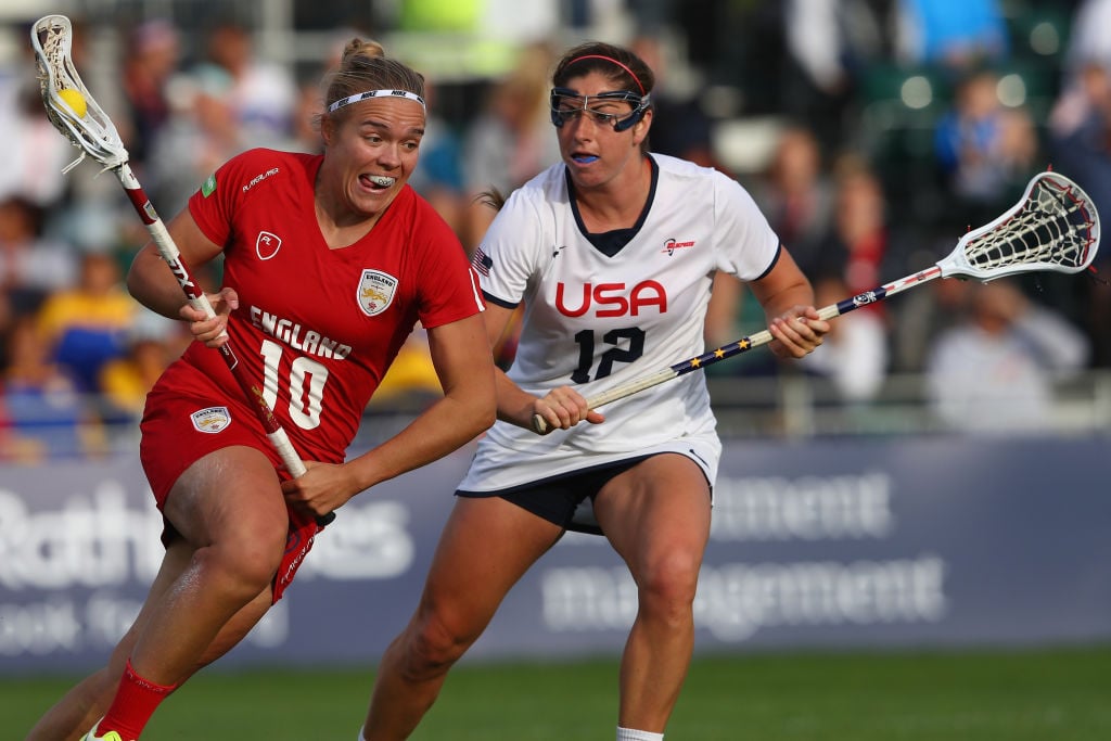 Annie Hillier (L) of England is tracked by Kayla Treanor (R) of USA during the semi-final match between England and USA during the 2017 FIL Rathbones Women's Lacrosse World Cup.