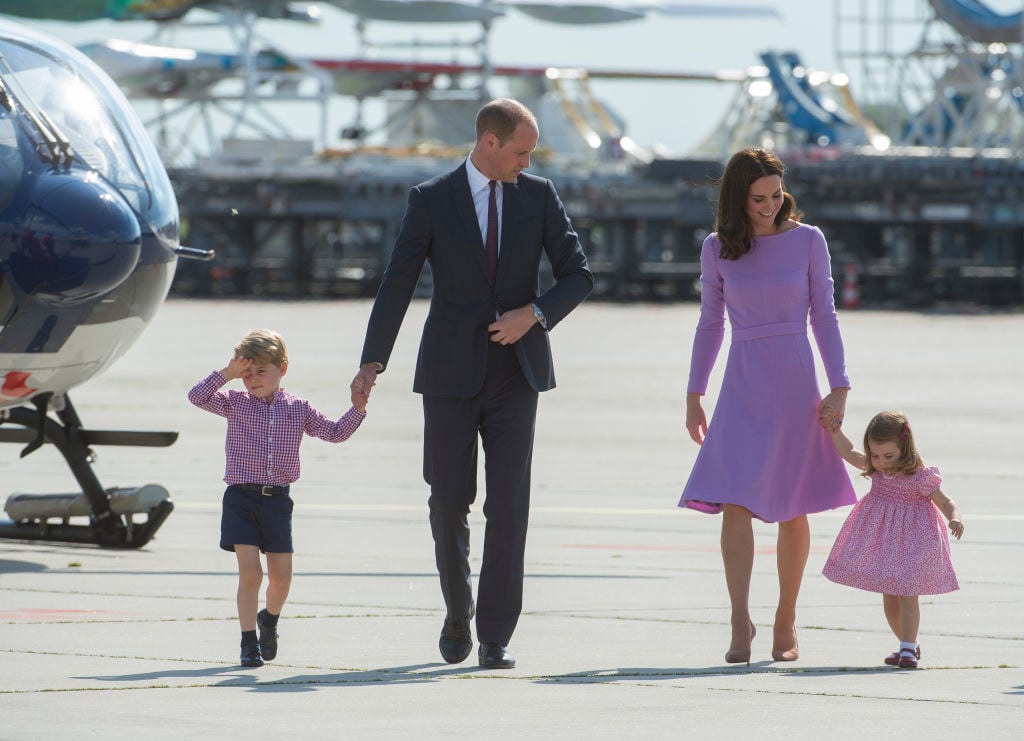 Prince William, Kate Middleton, and their kids at an airport Prince William, Kate Middleton, and their kids at an airport