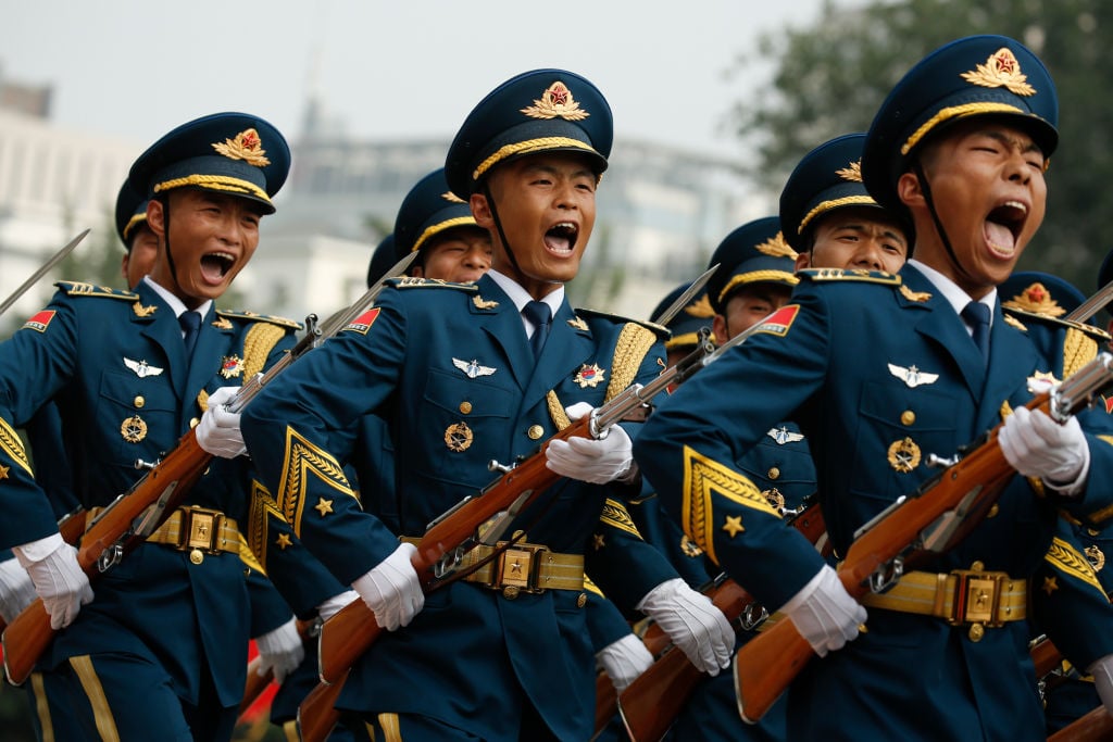 Marching honour guards shout during a welcoming ceremony in Beijing.