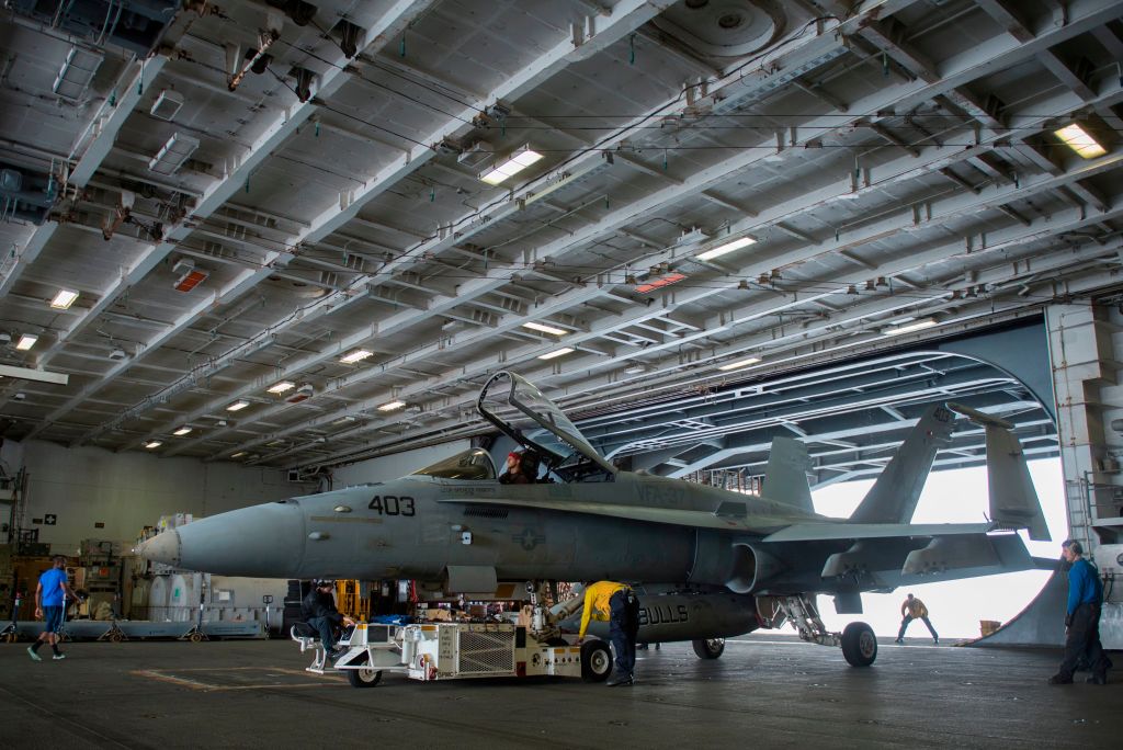 An F/A-18 Hornet is seen in the hangar of the USS George H.W. Bush An F/A-18 Hornet is seen in the hangar of the USS George H.W. Bush