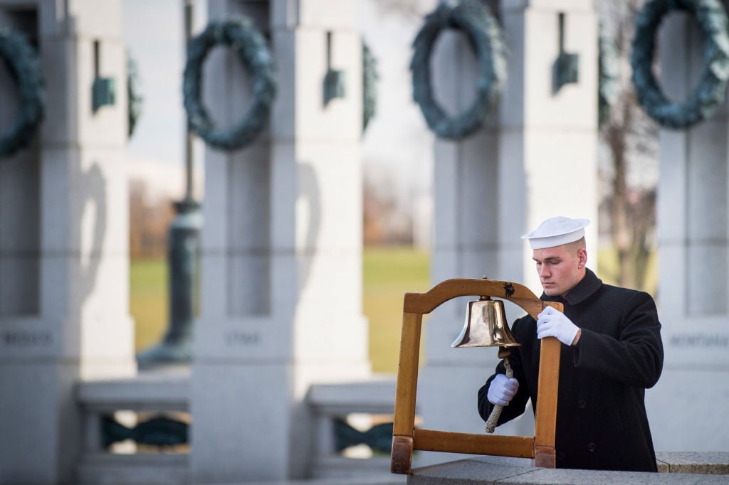 A serviceman with the US Navy, ring a ships bell to mark the time of the Japanese attack on Pearl Harbor during the Friends of the National World War II Memorial and the National Park Service, commemorate Pearl Harbor Remembrance Day A serviceman with the US Navy, ring a ships bell to mark the time of the Japanese attack on Pearl Harbor during the Friends of the National World War II Memorial and the National Park Service, commemorate Pearl Harbor Remembrance Day