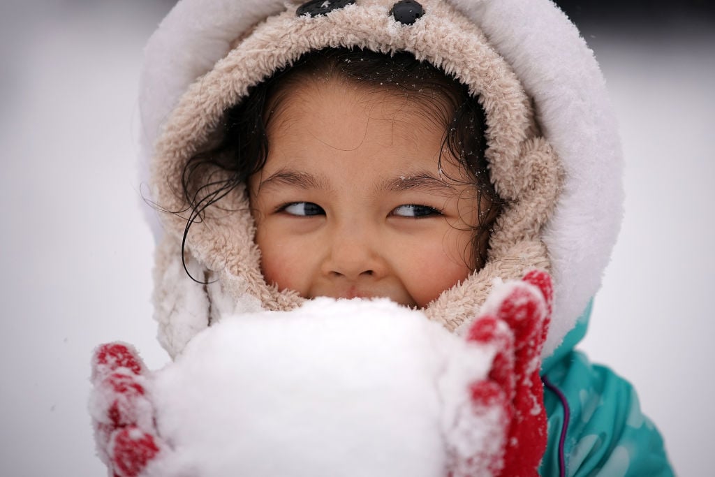 Little girl holding a snowball