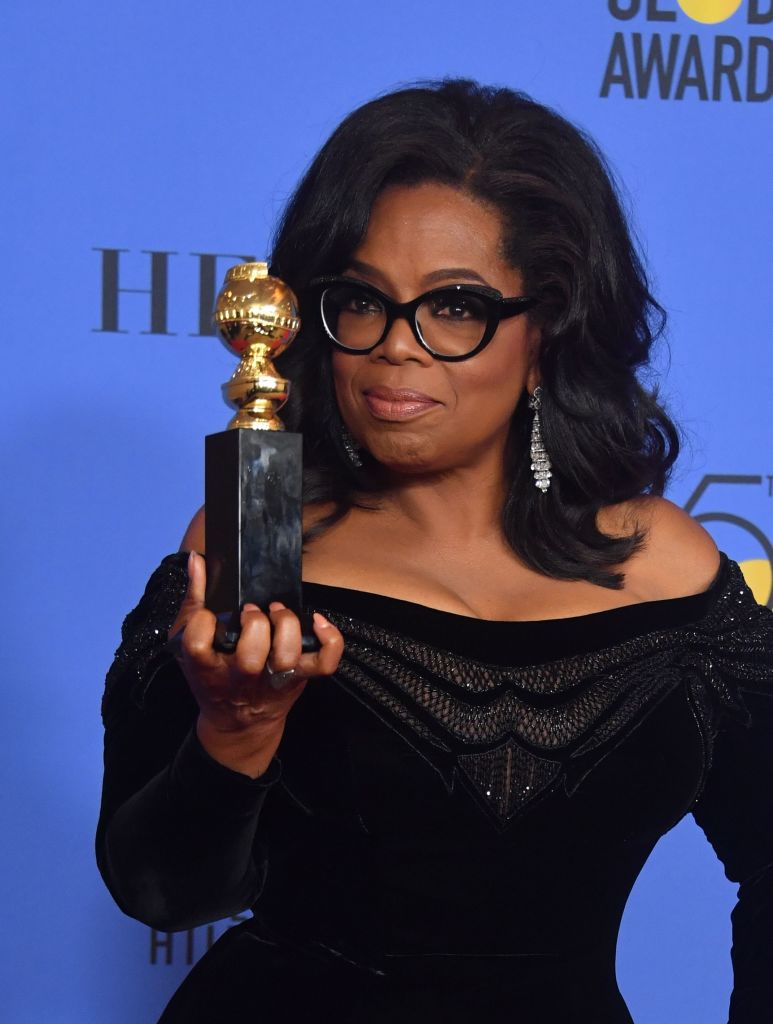 Actress and TV talk show host Oprah Winfrey poses with the Cecil B. DeMille Award during the 75th Golden Globe Awards oprah winfrey with her award