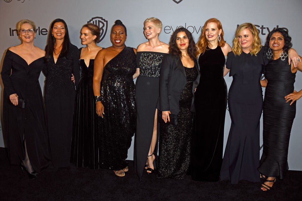 Many women dressed in black smiling and posing together