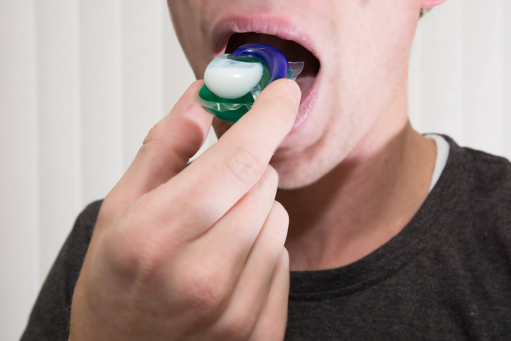 person putting laundry pod in mouth