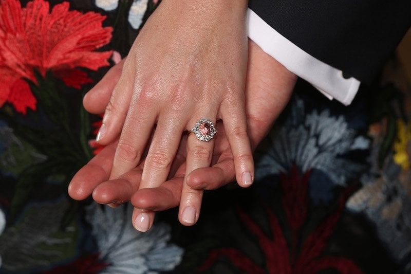 Britain's Princess Eugenie of York (L), displays her engagement ring containing a padparadscha sapphire surrounded by diamonds, as she poses with her fiance Jack Brooksbank in the Picture Gallery at Buckingham Palace in London on January 22, 2018, after the announcement of their engagement. Britain's Princess Eugenie of York (L), displays her engagement ring containing a padparadscha sapphire surrounded by diamonds, as she poses with her fiance Jack Brooksbank in the Picture Gallery at Buckingham Palace in London on January 22, 2018, after the announcement of their engagement.
