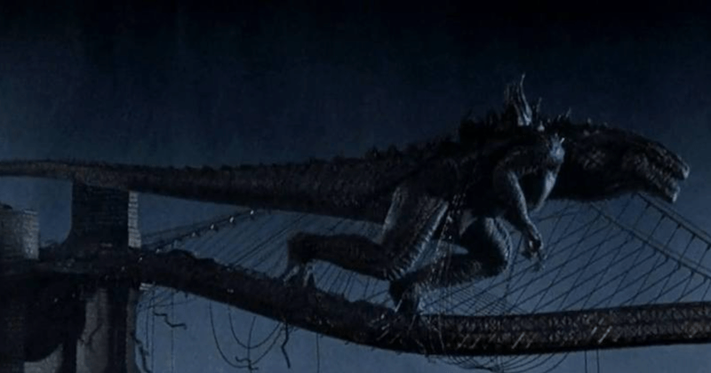 Godzilla walks across a bridge. Godzilla walks across a bridge.