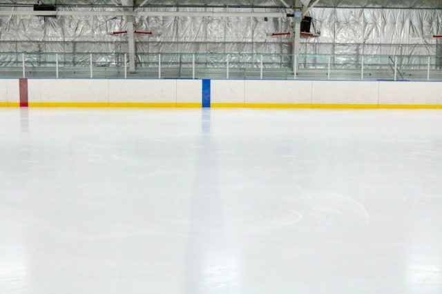 An empty ice skating rink. An empty ice skating rink.