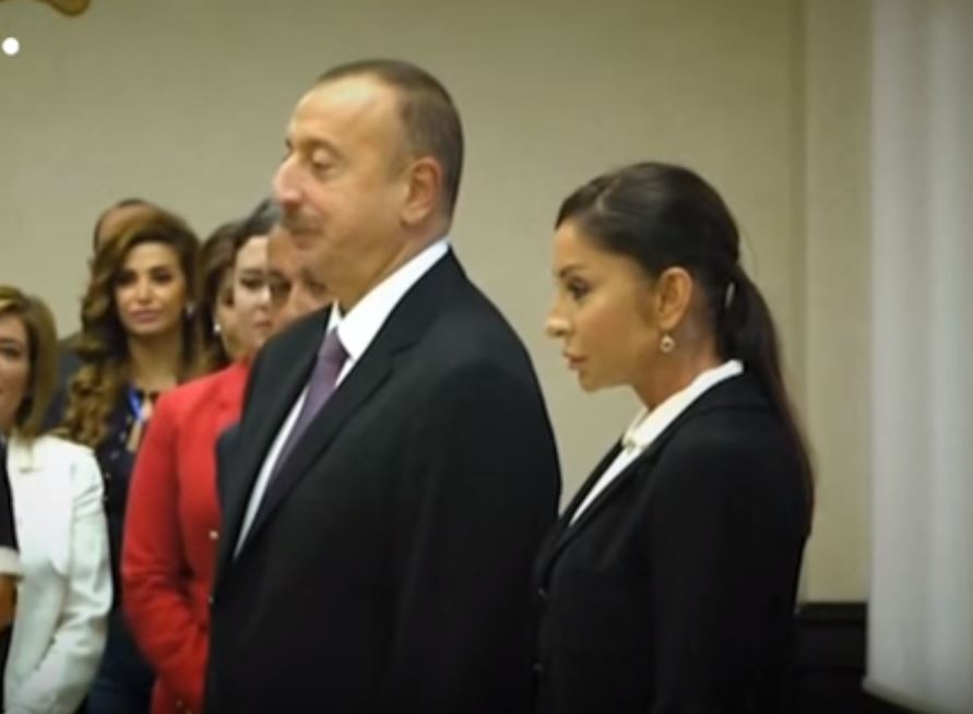 The President of Azerbaijan, Ilham Aliyev, and his wife pause before voting in an election
