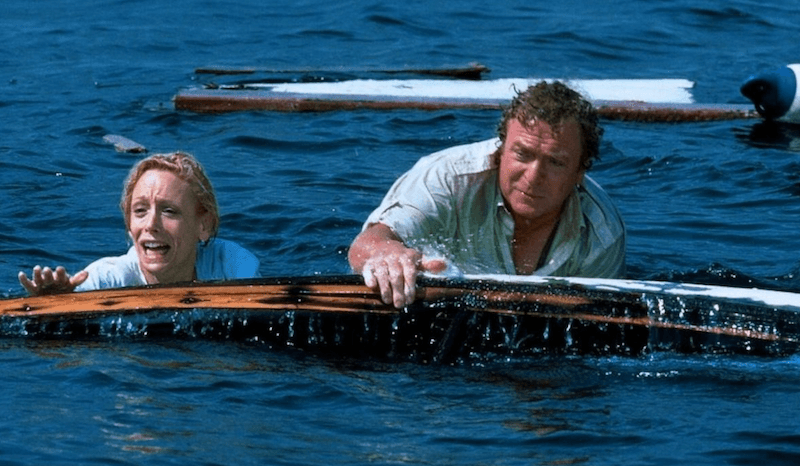 Two characters in water holding on to fragments of a boat. Two characters in water holding on to fragments of a boat.