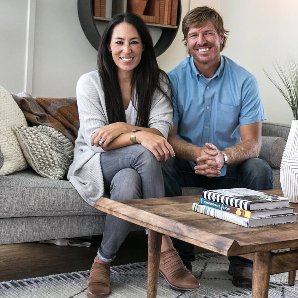 Joanna and Chip Gaines sitting on couch
