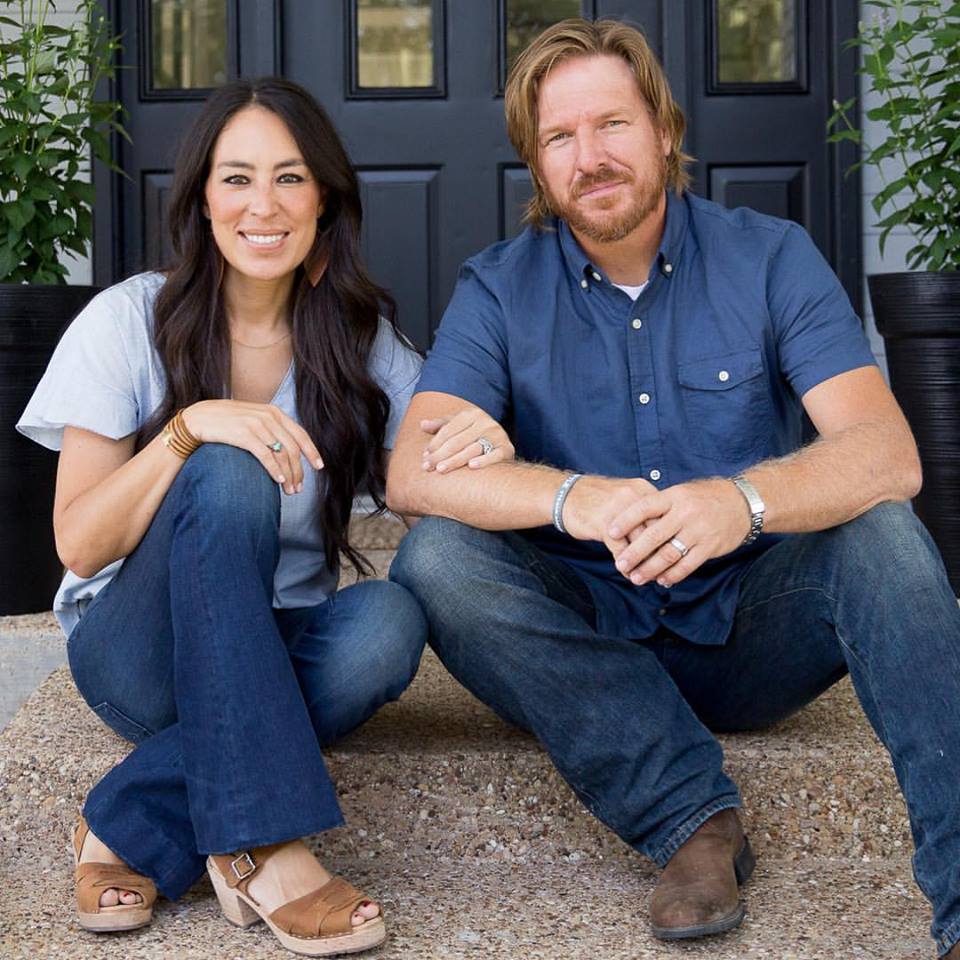 Joanna and Chip Gaines sitting on front step