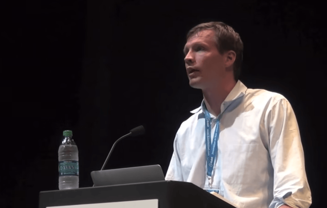 Justin Cadlebeck speaking into a microphone