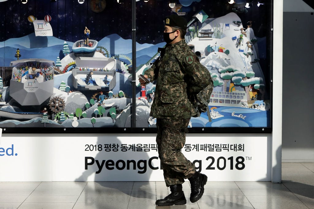A South Korean soldier walks past the 2018 PyeongChang Winter Olympic and Paralympic Games