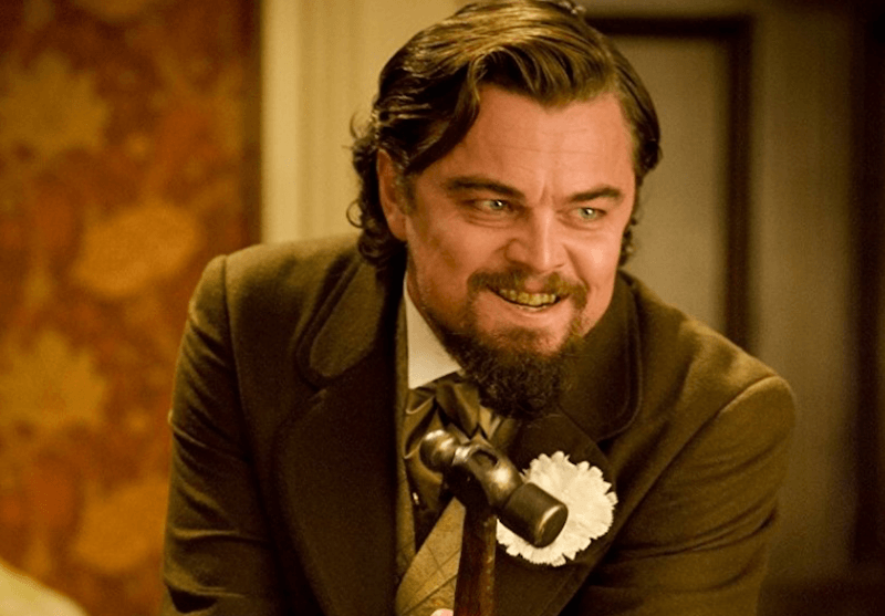 Leonardo DiCaprio holds a hammer and laughs in 'Django Unchained'.