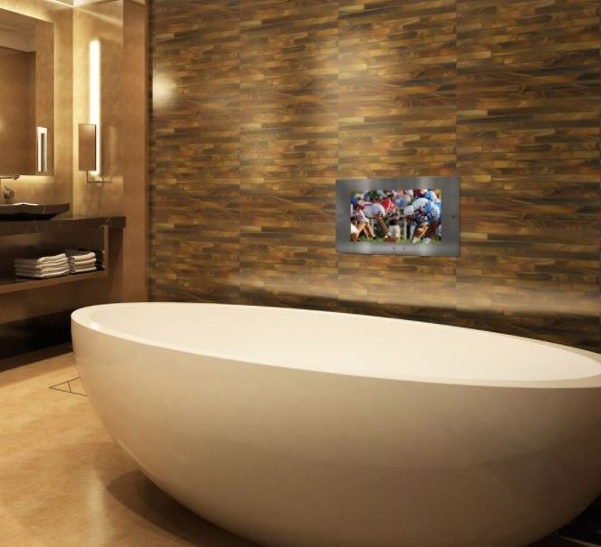 A Lightology Mirrored Waterproof TV installed above a bathtub