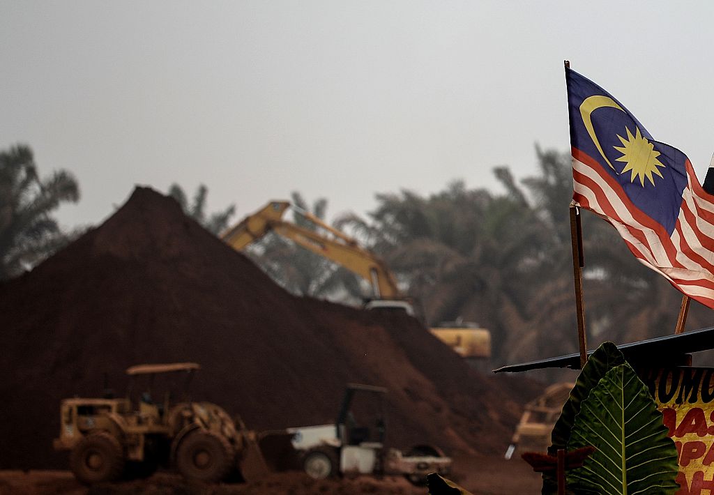 a Malaysian flag flies at the entry-point to a Bauxite mining site in Bukit Goh situated in Malaysia's rural state of Pahang