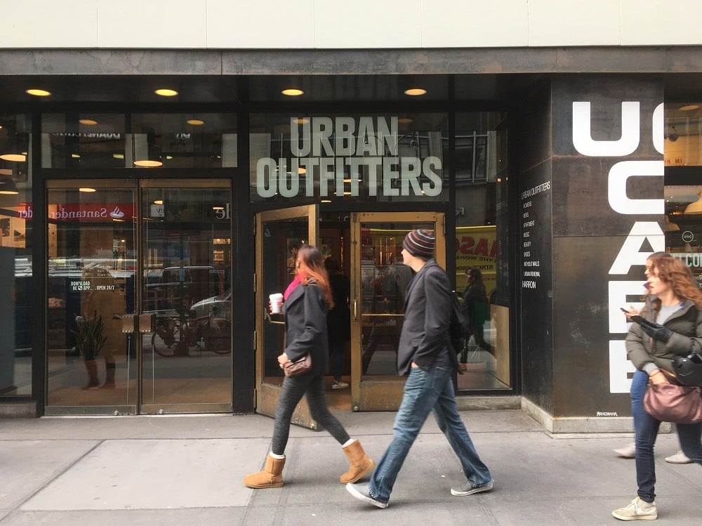 Man and woman walk past Urban Outfitters