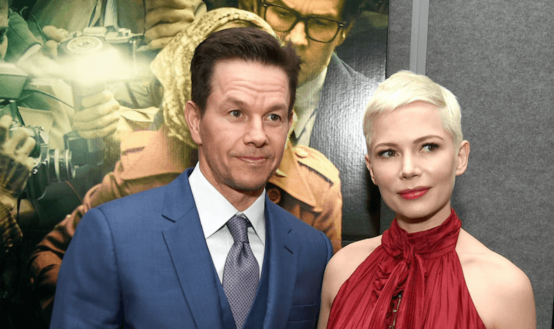 Mark Wahlberg and Michele Williams posing together in front of a movie poster. Mark Wahlberg and Michele Williams posing together in front of a movie poster.