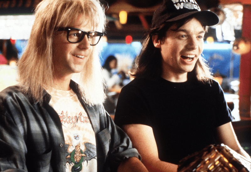Two characters laughing and smiling as they stand together in a bar. Two characters laughing and smiling as they stand together in a bar.